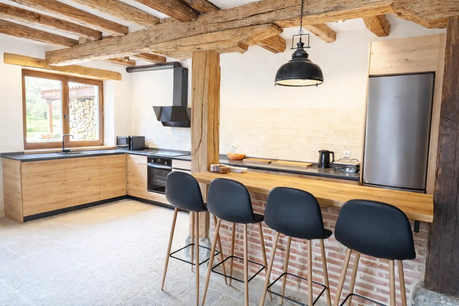 Open kitchen with central island flowing into the living area at Cumbres de Lores